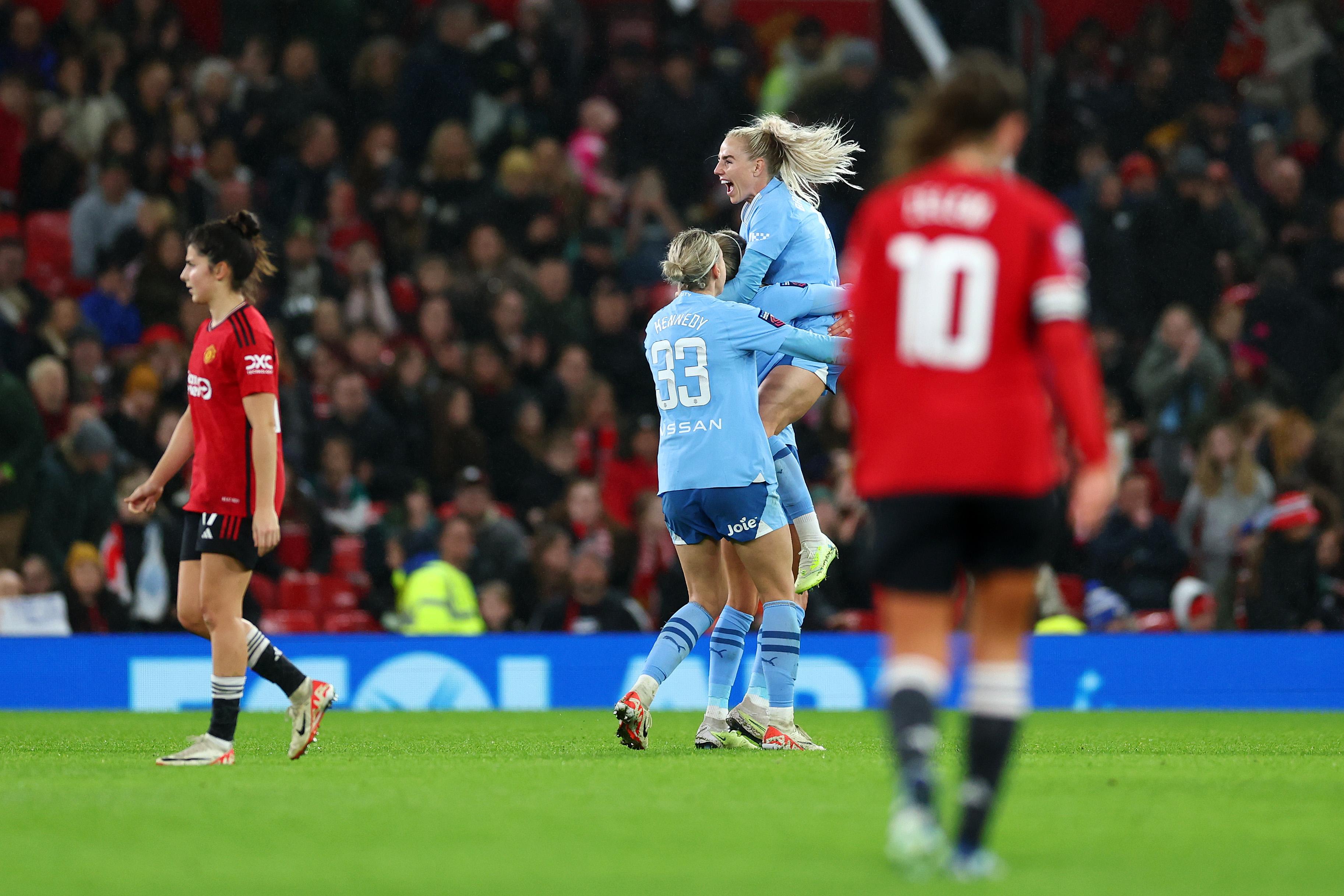 Manchester City players celebrate in front of Manchester United players during the WSL derby